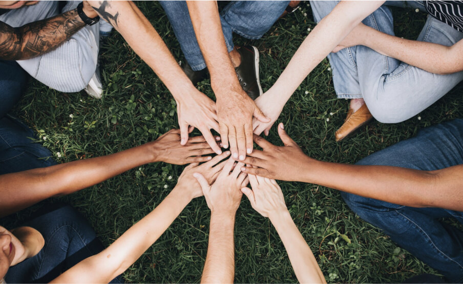 Group of people holding hands in a circle